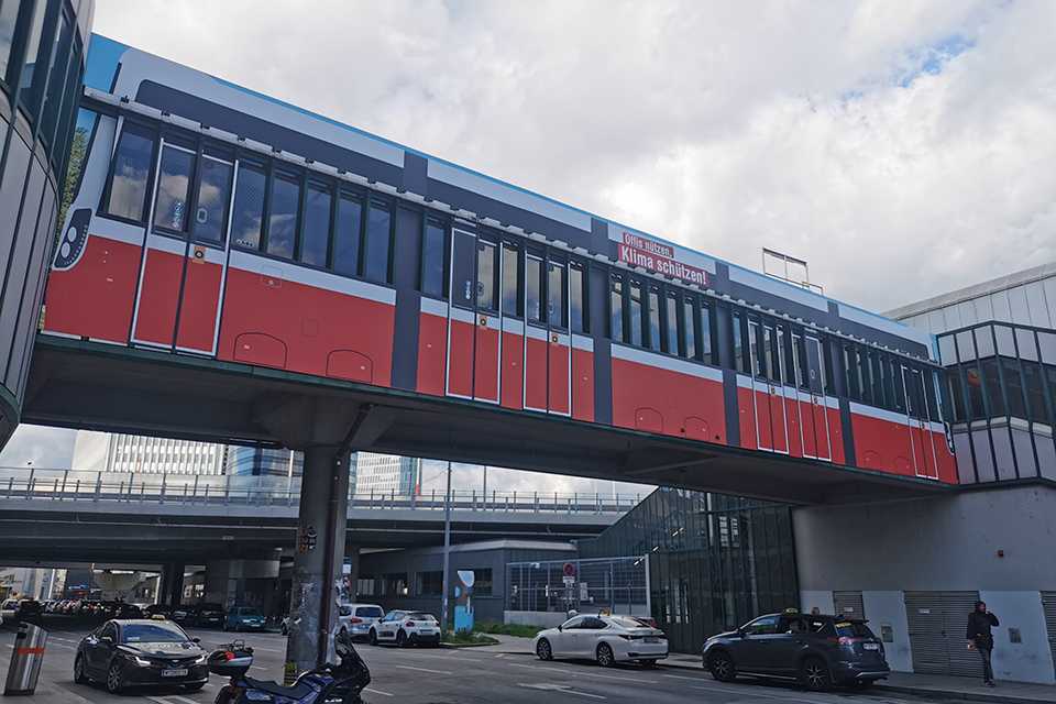 Branding Steg Erdberg: Wiener Linien Werbung mit Straßenbahn-Motiv. Öffi-Nutzen, Klima schützen!