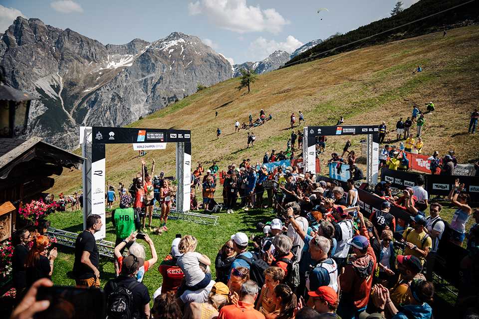 Siegerehrung Vertical WM Trailrunning Tirol 2023. Läuferinnen feiern vor Bergkulisse und Publikum.